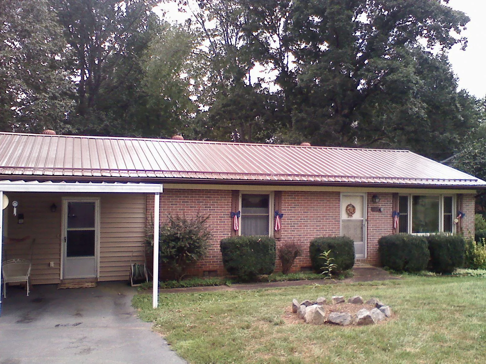 Bronze metal roof and carport on a brick ranch home — Roof Repair work by our crew in Arden